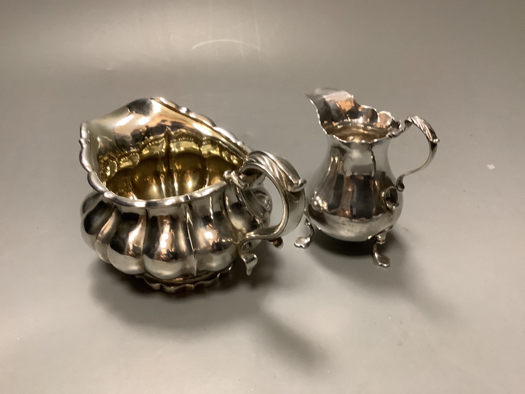 A George III silver baluster cream jug and a George IV silver cream jug 10.9oz